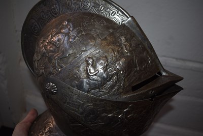 Lot 388 - AN EMBOSSED CLOSE HELMET IN THE EARLY 17TH CENTURY MANNER