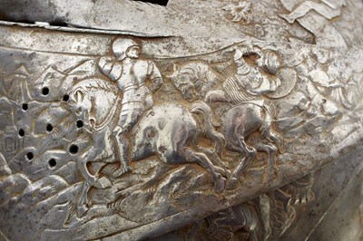 Lot 388 - AN EMBOSSED CLOSE HELMET IN THE EARLY 17TH CENTURY MANNER