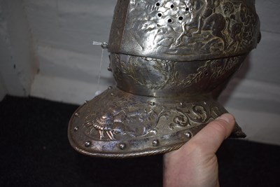 Lot 388 - AN EMBOSSED CLOSE HELMET IN THE EARLY 17TH CENTURY MANNER