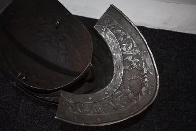 Lot 388 - AN EMBOSSED CLOSE HELMET IN THE EARLY 17TH CENTURY MANNER