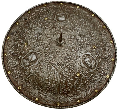 Lot 402 - AN ITALIAN EMBOSSED SHIELD IN THE MILANESE RENAISSANCE STYLE