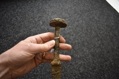 Lot 830 - AN IRON AGE SWORD IN EXCAVATED CONDITION