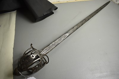 Lot AN 18TH CENTURY SCOTTISH BASKET HILTED BROAD SWORD